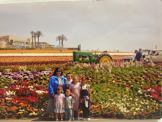 Mom and 4 children standing in front of the flower fields on a homeschool Field Trip
