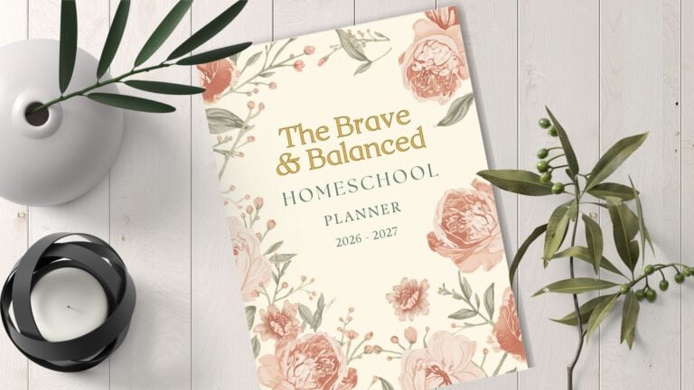 The Brave And Balanced Homeschool PLanner sitting on a table top with a plant next to it
