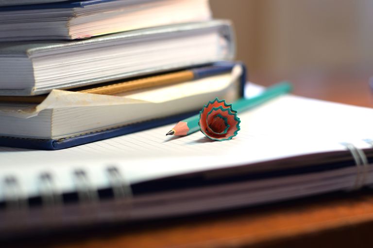 Close-up of books and sharpened pencil on a desk in São Paulo, ideal for educational content. Grading Homeschool Assignments
